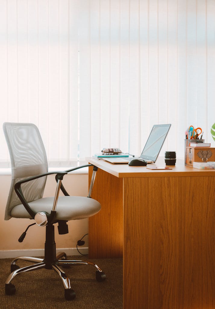 Kunden Mittelstand A tranquil modern home office featuring a wooden desk, ergonomic chair, and soft natural light.